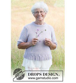 Damestrui met korte mouwen en gebreide kwastjesrand langs de boord gemaakt van Drops Kid Silk