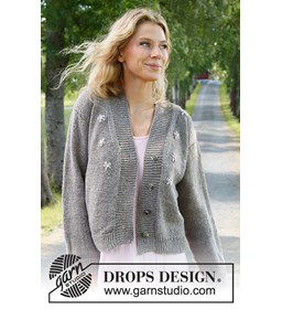 Damesvest met geborduurde bloemetjes, brede hals- en knoopbies. gemaakt van Drops Merino extra fine