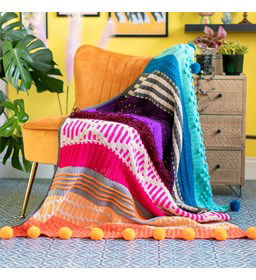 Deken met pompons gemaakt van Scheepjes Colour Crafter